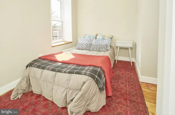 a bedroom with a bed and a window