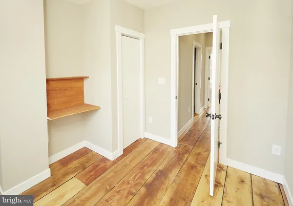 a view of a bedroom from a hallway
