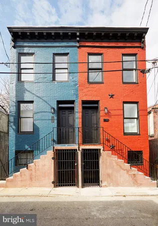 a front view of a house with a parking space