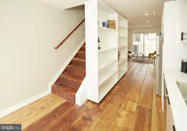 a view of entryway and hall with wooden floor