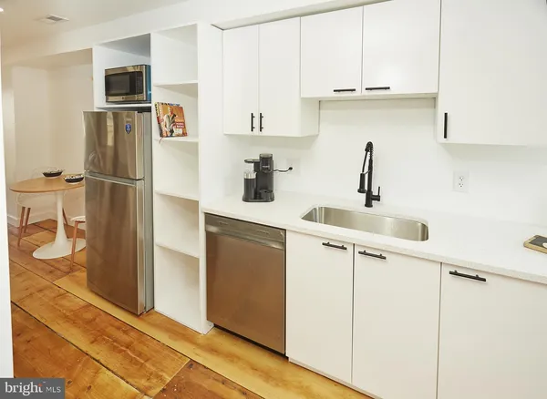 a kitchen with stainless steel appliances a refrigerator sink and cabinets
