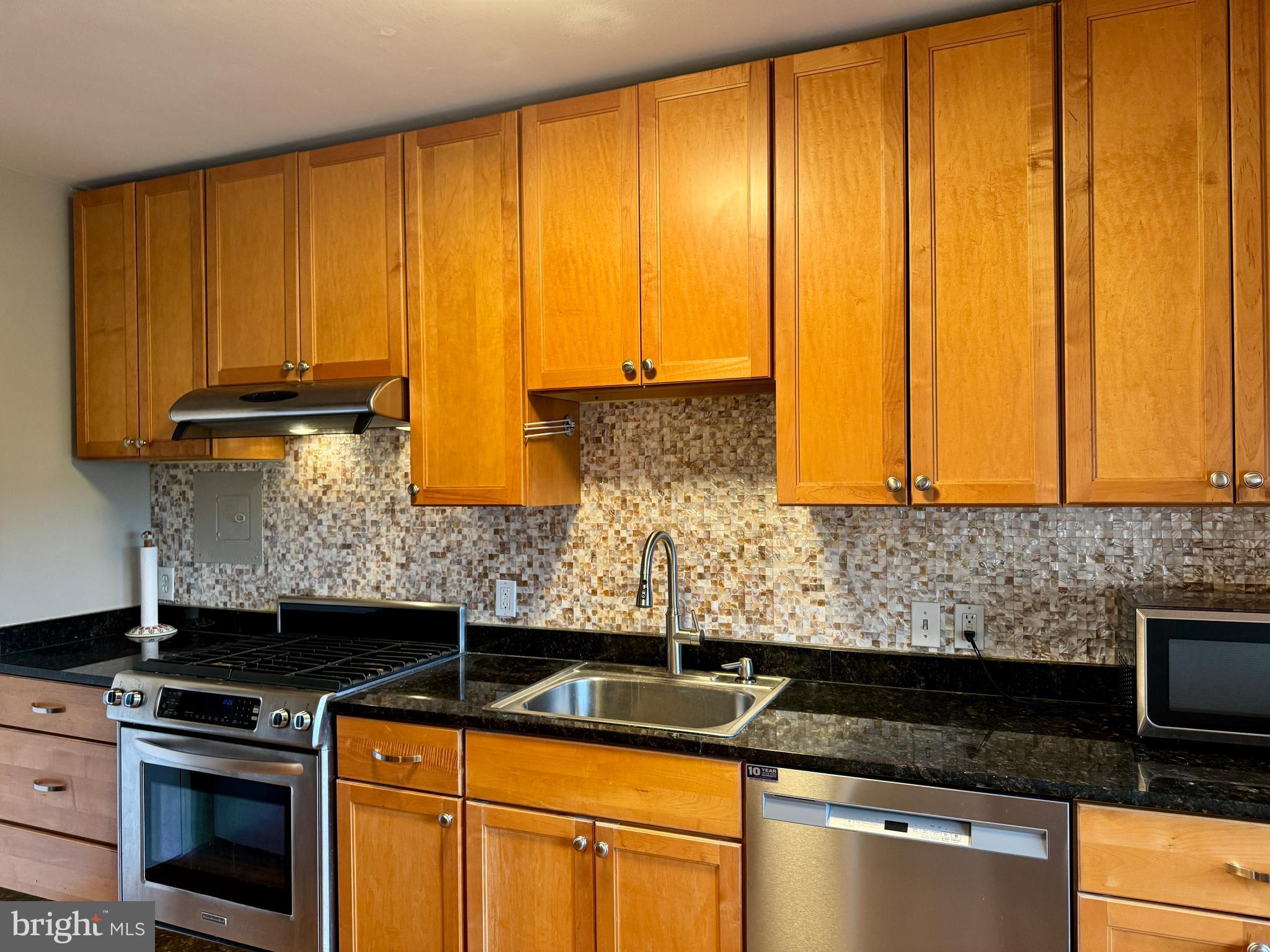 7900 Old York Road, Unit 814A Elkins Park, PA 19027 - Photo 11 of 43 a kitchen with stainless steel appliances granite countertop cabinets sink and window