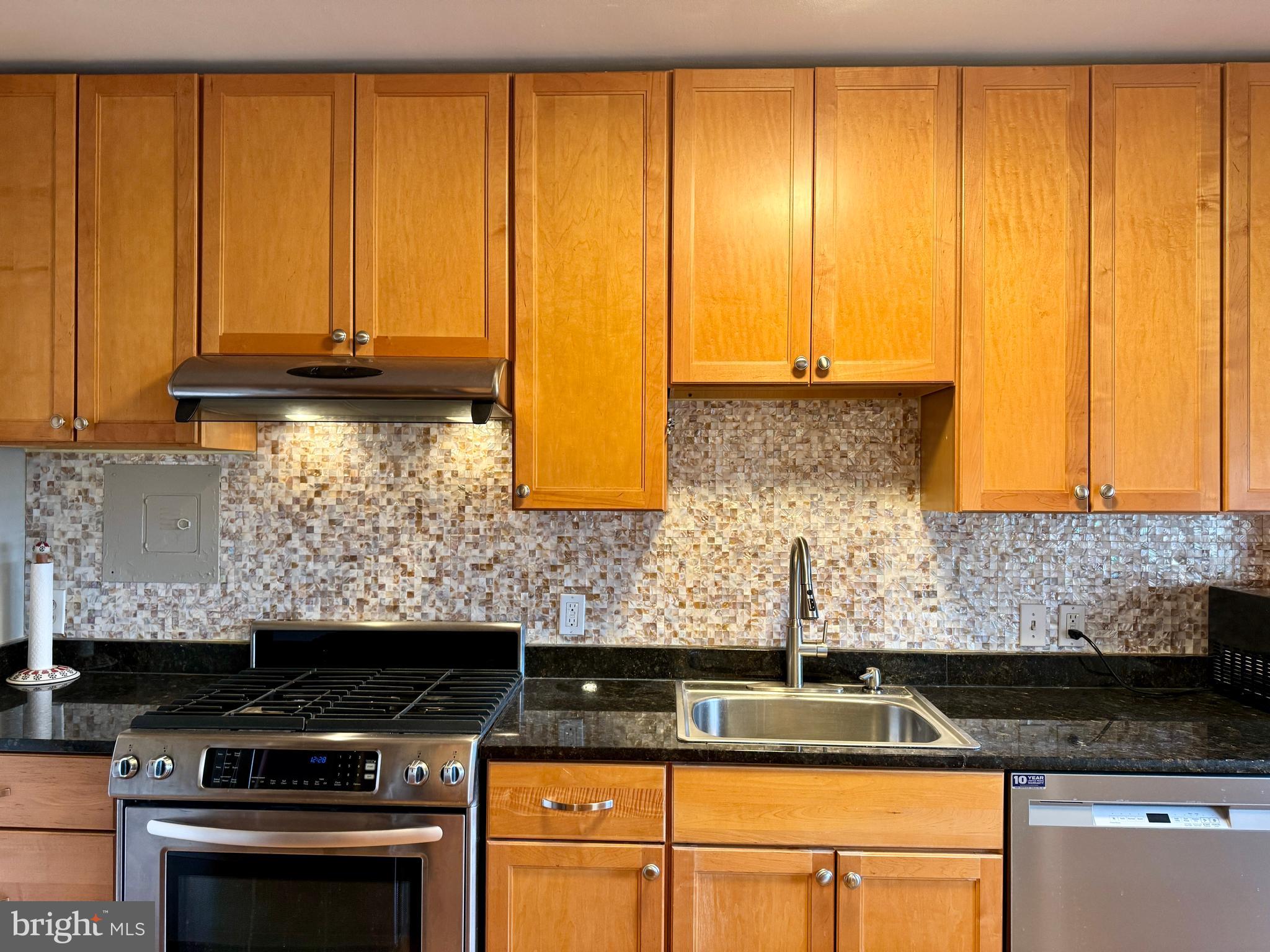 7900 Old York Road, Unit 814A Elkins Park, PA 19027 - Photo 12 of 43 a kitchen with granite countertop cabinets and black stainless steel appliances