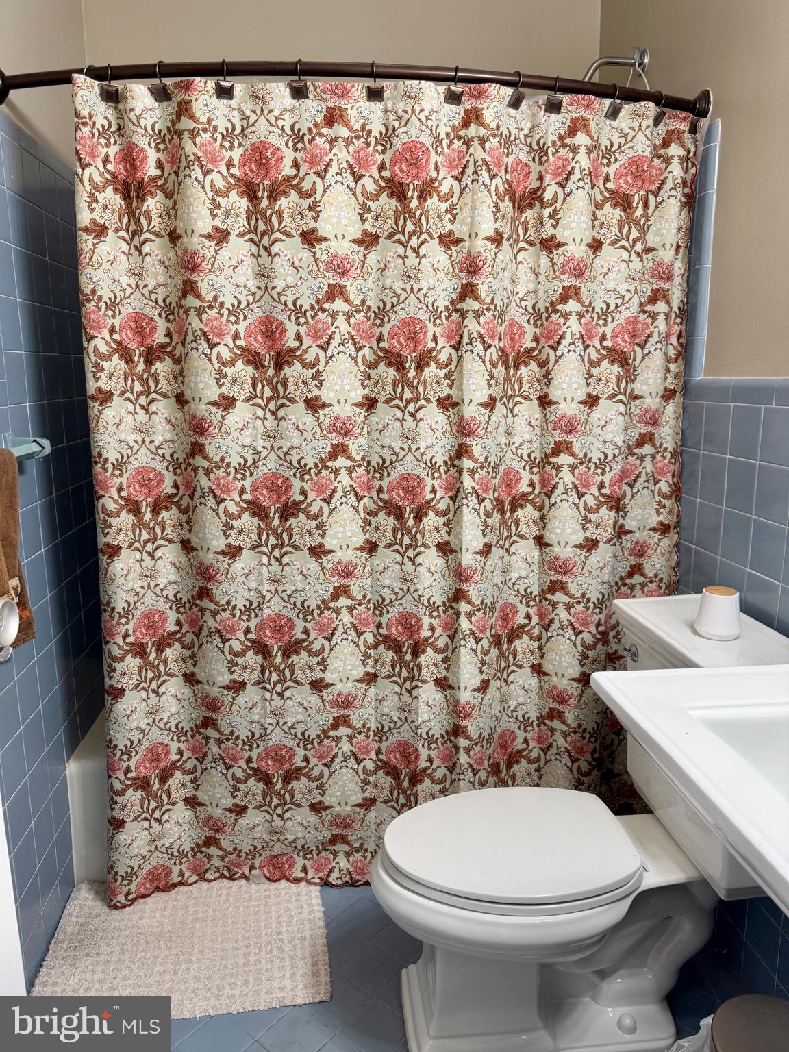7900 Old York Road, Unit 814A Elkins Park, PA 19027 - Photo 30 of 43 a white toilet sitting next to a shower curtain
