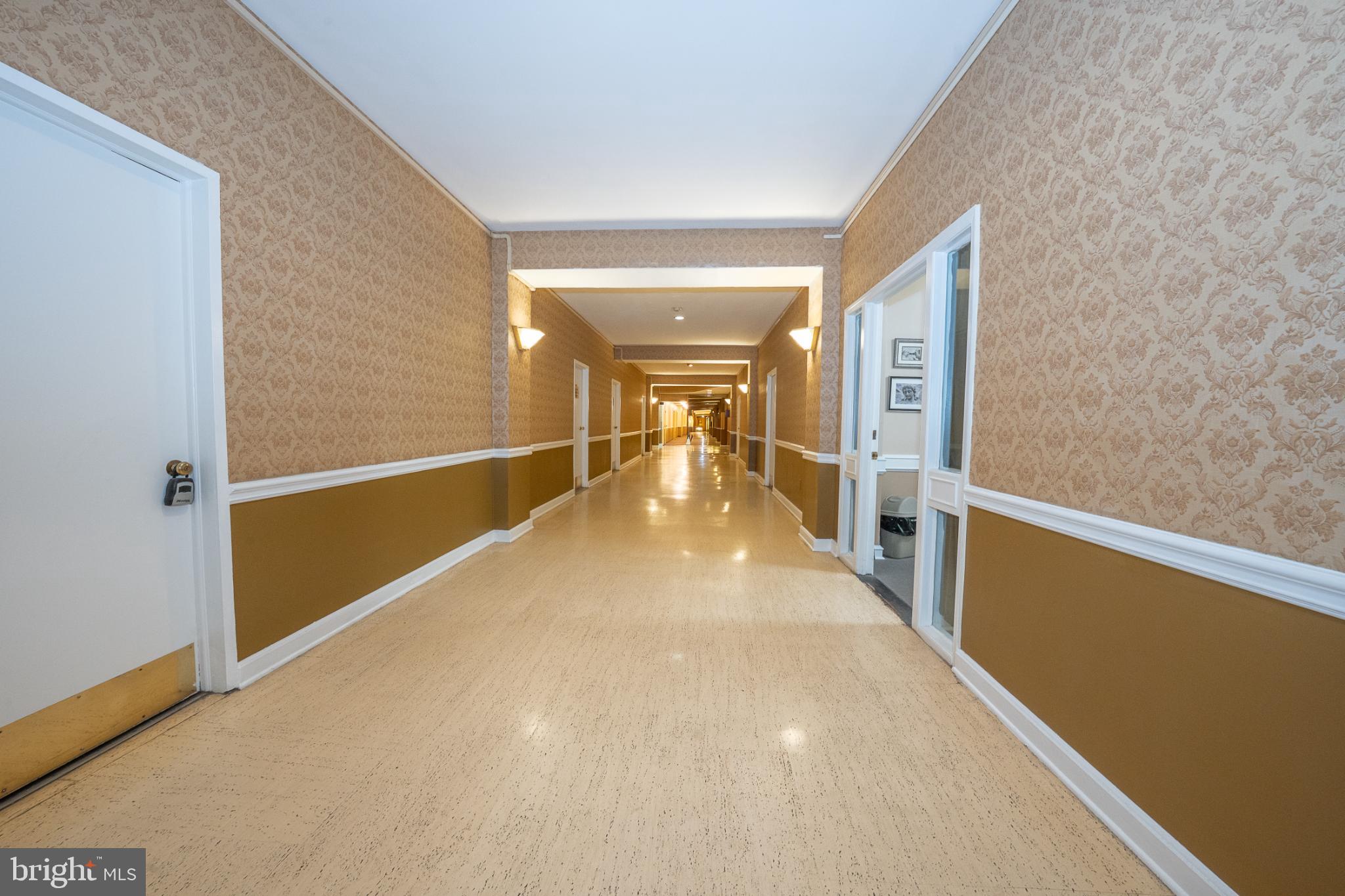 7900 Old York Road, Unit 814A Elkins Park, PA 19027 - Photo 7 of 43 a view of a hallway with wooden floor and staircase