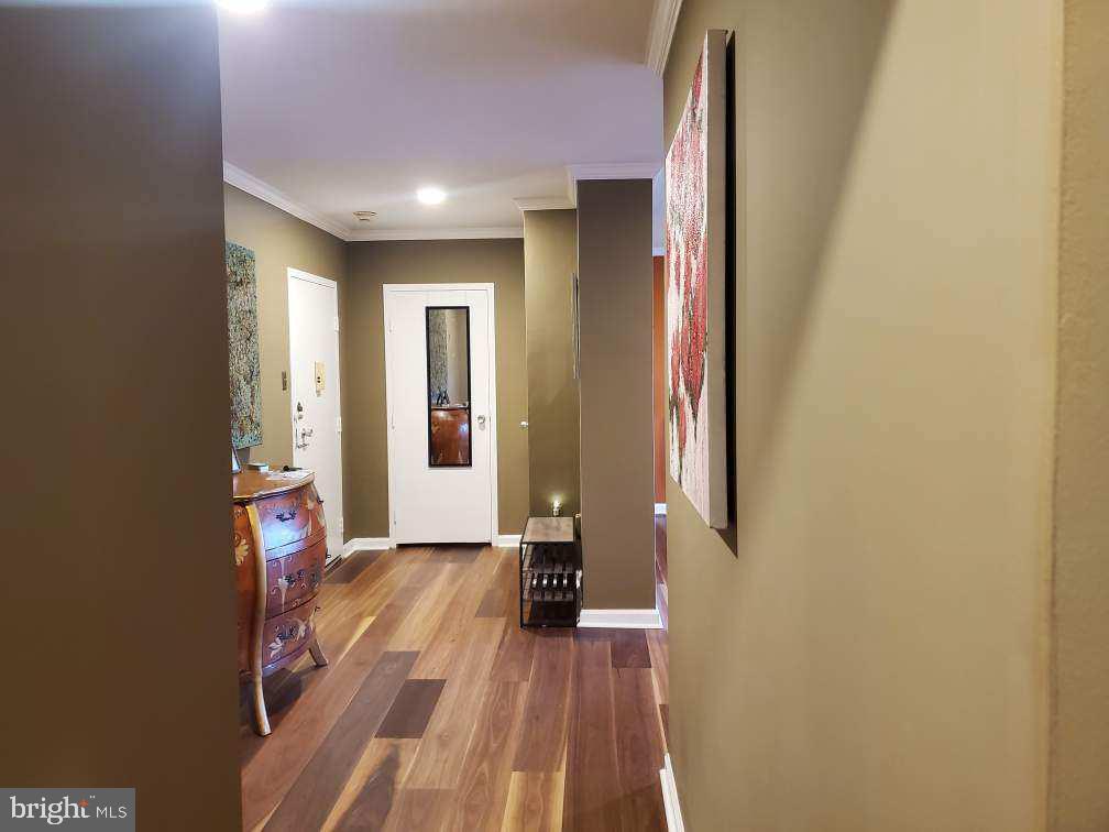 7900 Old York Road, Unit 814A Elkins Park, PA 19027 - Photo 9 of 43 a view of a hallway with wooden floor and staircase
