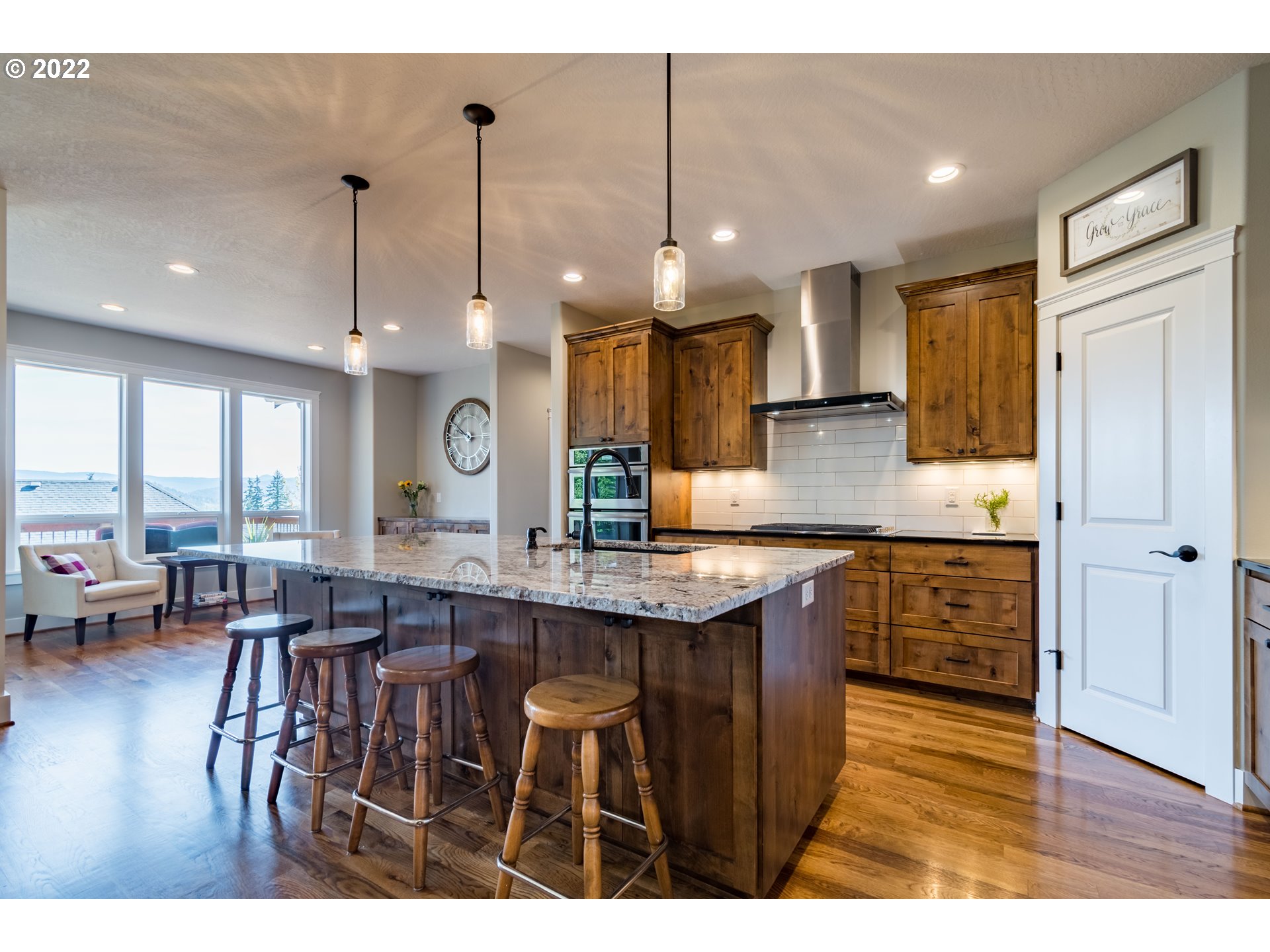 6074 Graystone Loop Springfield, OR 97478 - Photo 11 of 32 a kitchen with stainless steel appliances granite countertop a stove a refrigerator a sink dishwasher with a dining table and chairs