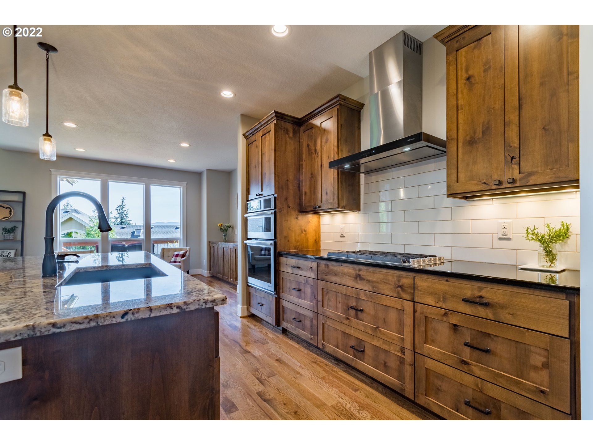 6074 Graystone Loop Springfield, OR 97478 - Photo 12 of 32 a kitchen with granite countertop wooden cabinets and stainless steel appliances