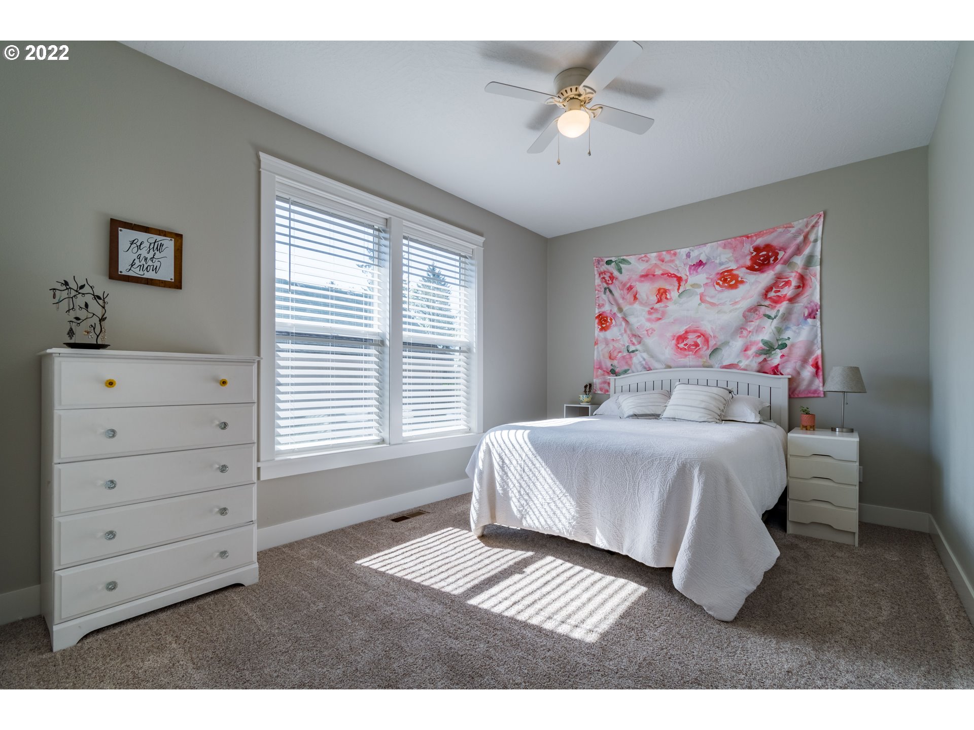 6074 Graystone Loop Springfield, OR 97478 - Photo 22 of 32 a bedroom with a bed and a chandelier