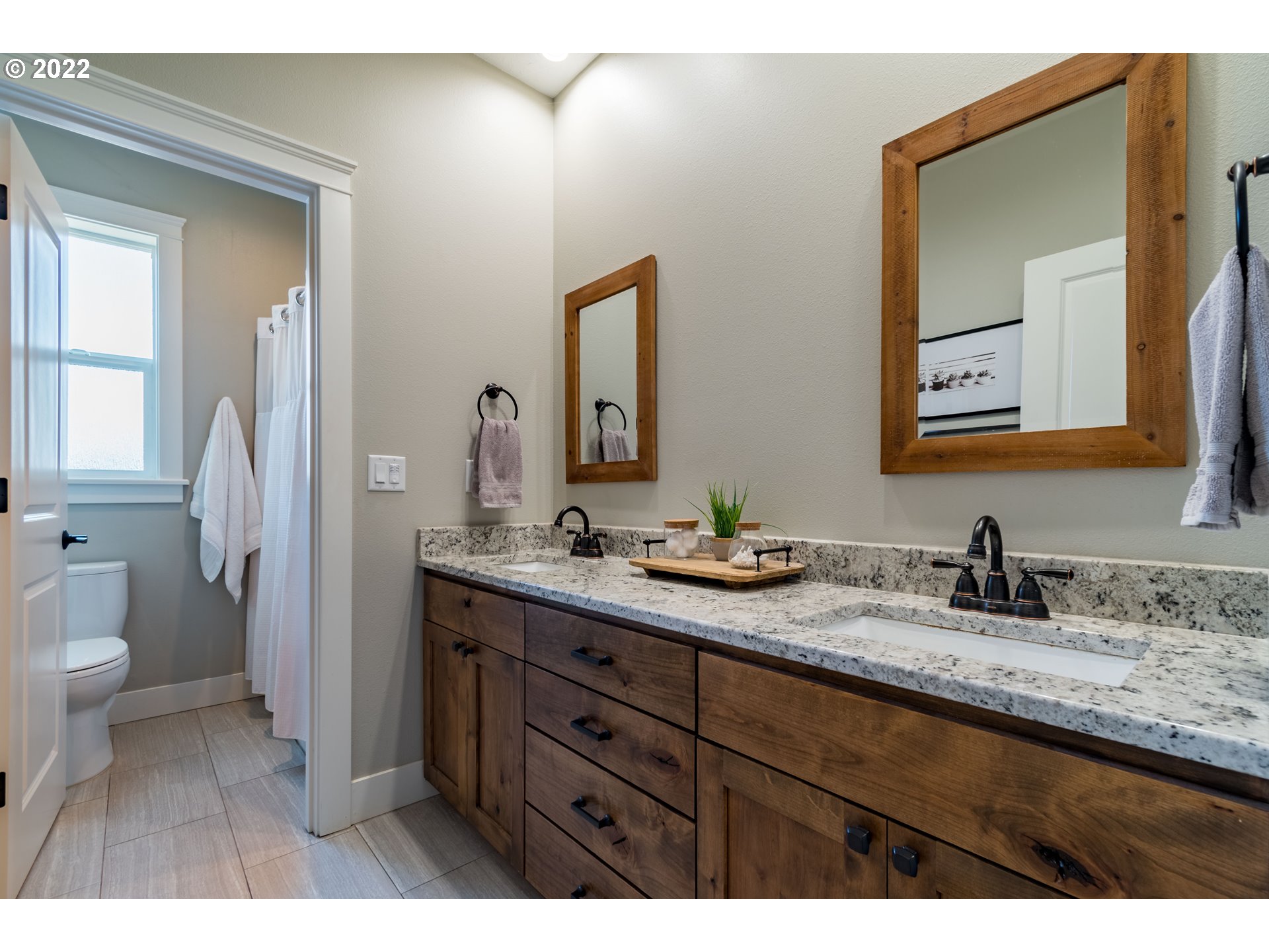 6074 Graystone Loop Springfield, OR 97478 - Photo 23 of 32 a bathroom with a granite countertop sink mirror and toilet