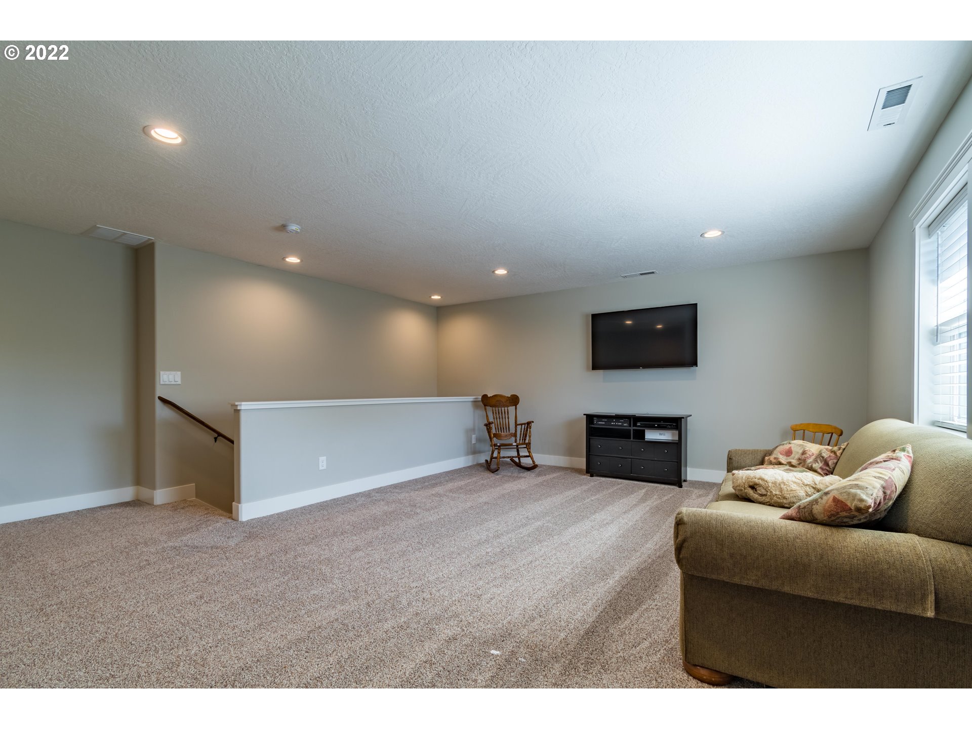 6074 Graystone Loop Springfield, OR 97478 - Photo 24 of 32 a living room with furniture and a flat screen tv