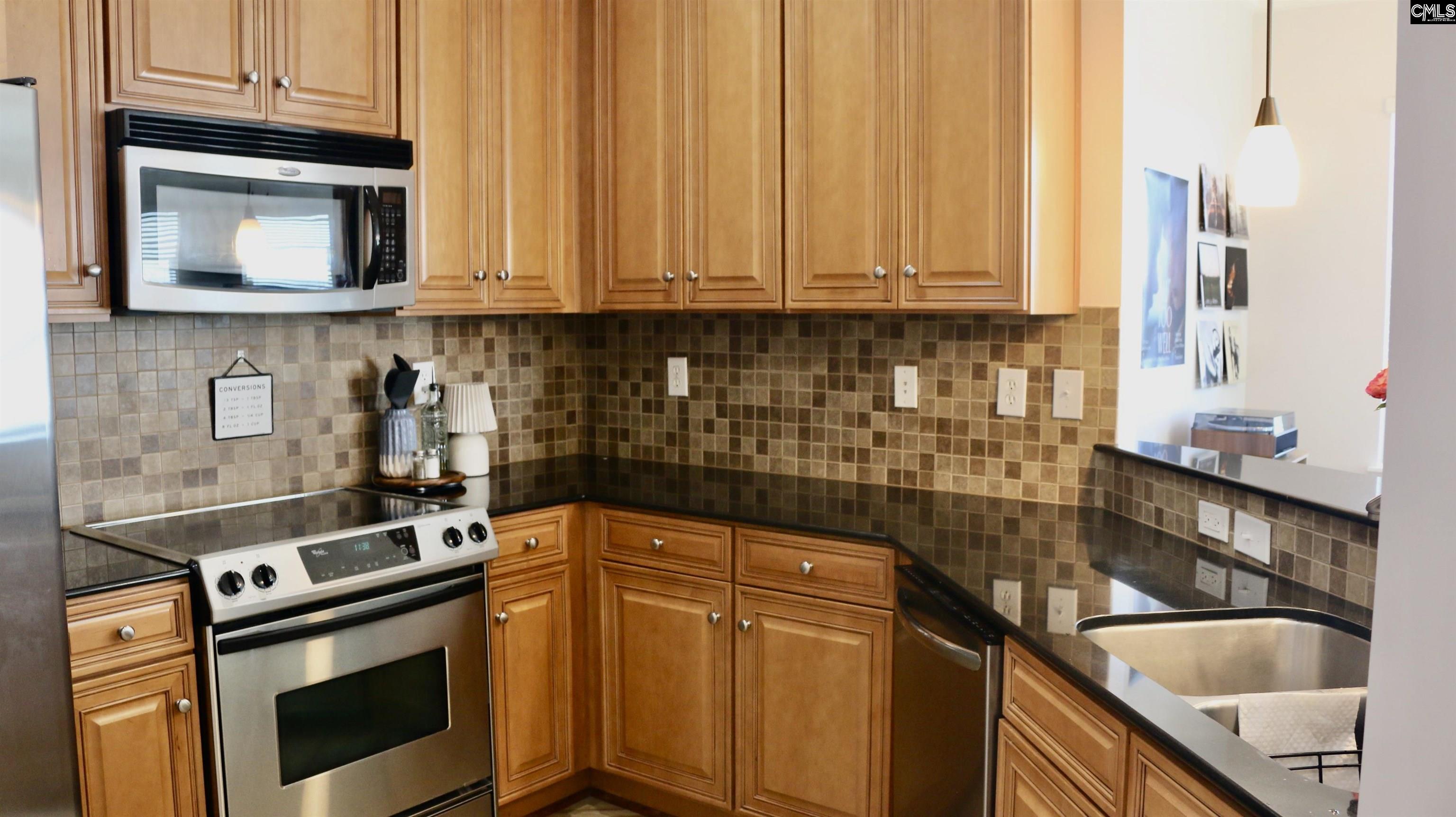 601 Main Street, Unit 323 Columbia, SC 29201 - Photo 11 of 68 a kitchen with granite countertop a stove sink and cabinets