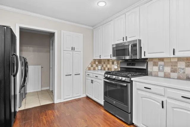 a kitchen with granite countertop a stove top oven sink and cabinets