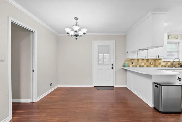 a view of a dining room with furniture and chandelier