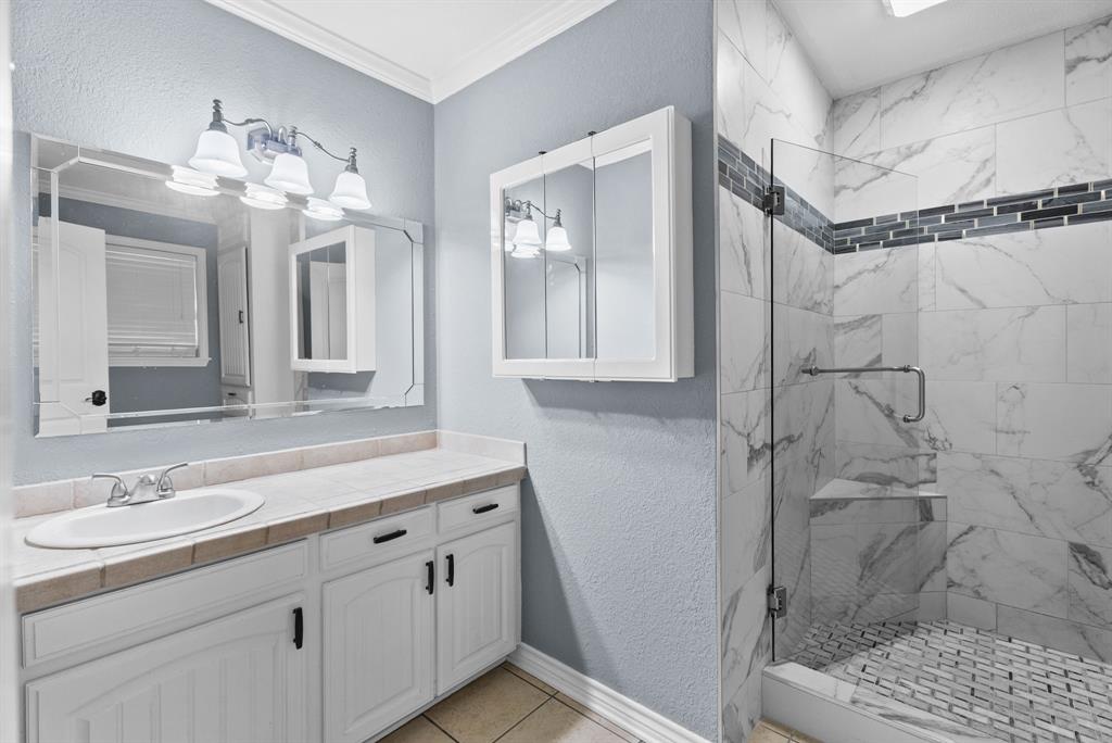 3217 Libbie Street Tyler, TX 75707 - Photo 19 of 35 a bathroom with a double vanity sink mirror and shower