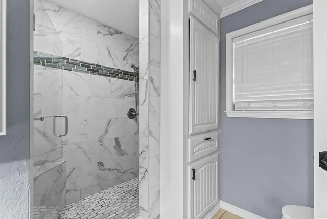a bathroom with a double vanity sink mirror and shower