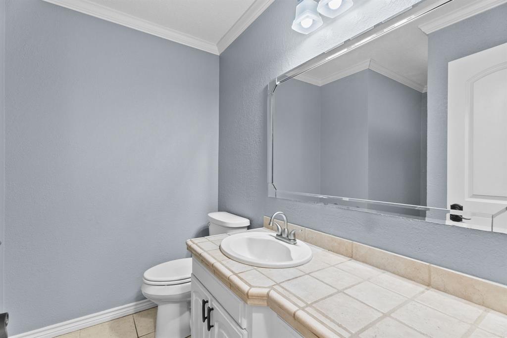 3217 Libbie Street Tyler, TX 75707 - Photo 23 of 35 a bathroom with a sink and a mirror