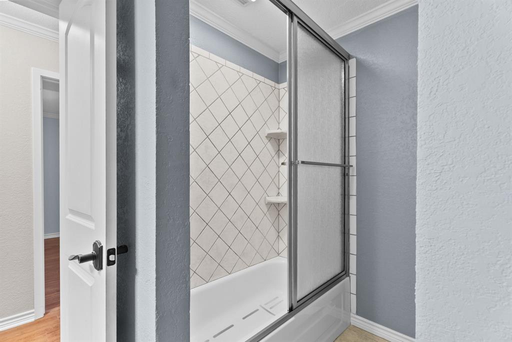 3217 Libbie Street Tyler, TX 75707 - Photo 24 of 35 a bathroom with a glass shower door