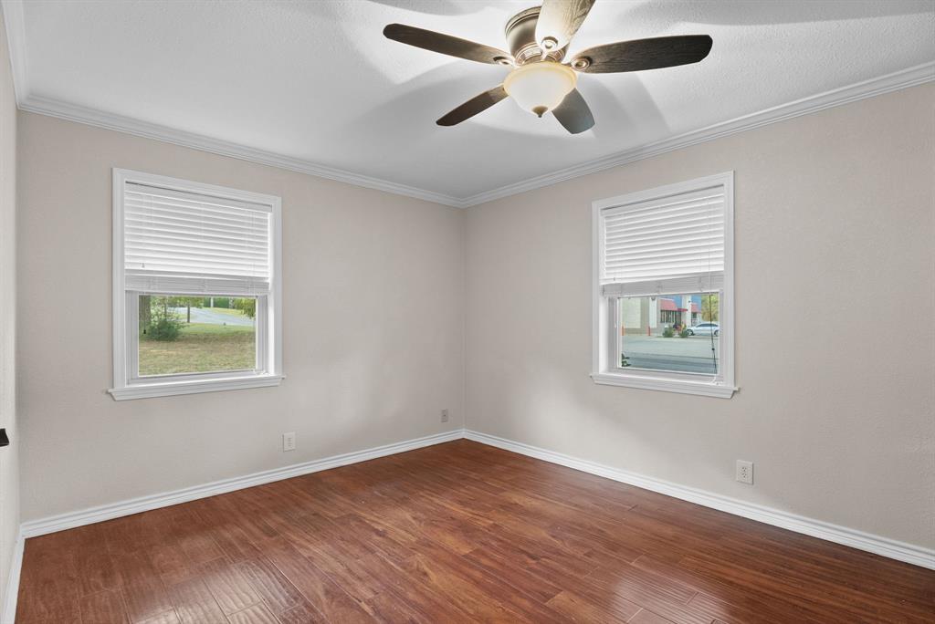 3217 Libbie Street Tyler, TX 75707 - Photo 25 of 35 a view of an empty room with wooden floor and a window