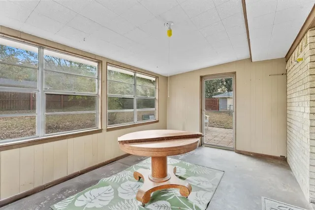 a room with a white cabinets and wooden floor