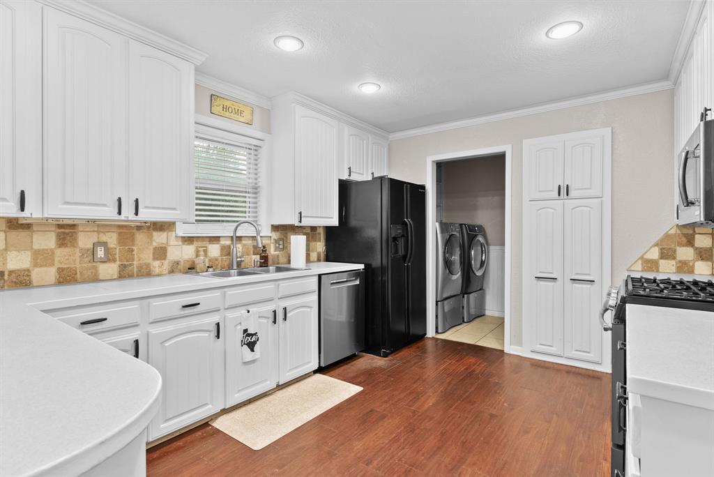 3217 Libbie Street Tyler, TX 75707 - Photo 8 of 35 a kitchen with granite countertop a refrigerator and a sink