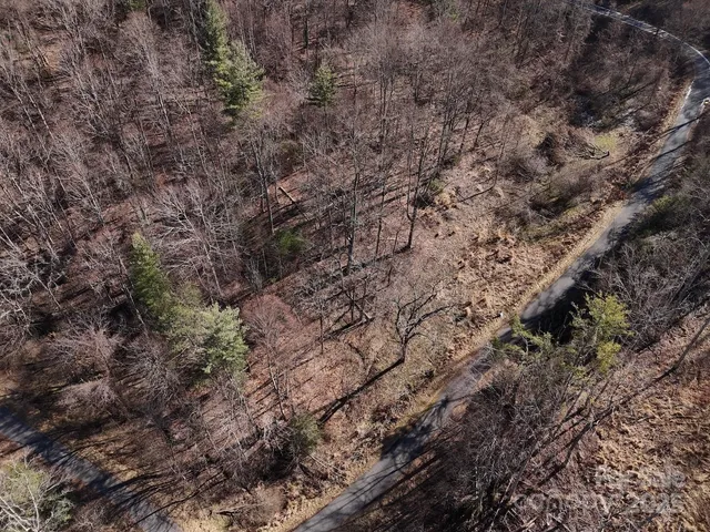 a view of a yard with wooden fence