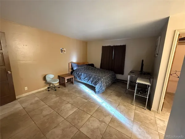 a bedroom with furniture and a window