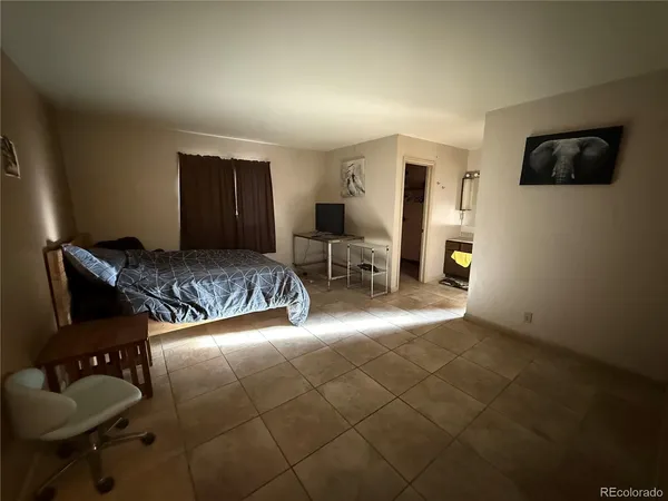 a bedroom with a bed and a television