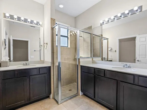 a bathroom with a double vanity sink mirror and double