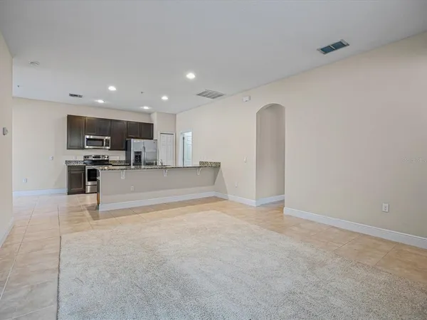 a view of kitchen with refrigerator and microwave