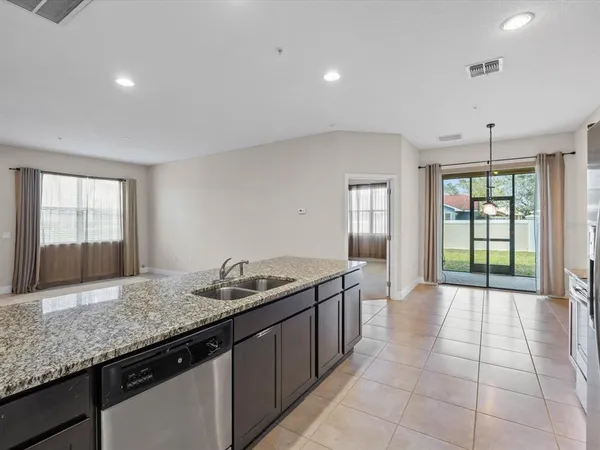 a kitchen with granite countertop a sink and a stove