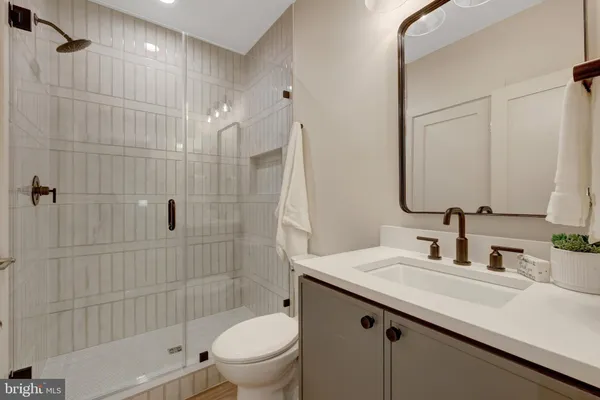 a bathroom with a sink toilet double vanity and shower