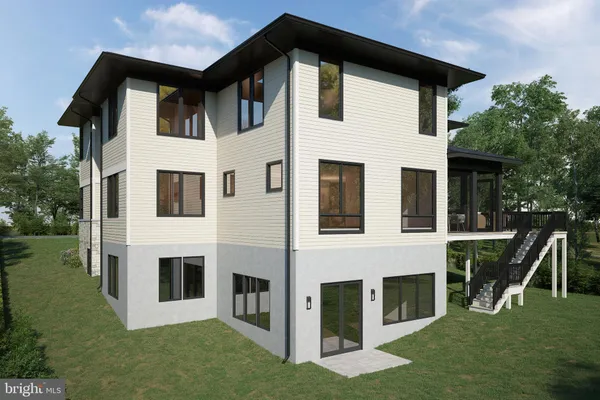 a white house with a big yard and large trees