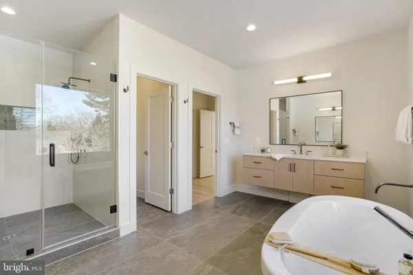 a en suite bathroom with a granite countertop sink mirror and shower