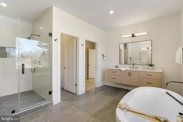 a en suite bathroom with a granite countertop sink mirror and shower