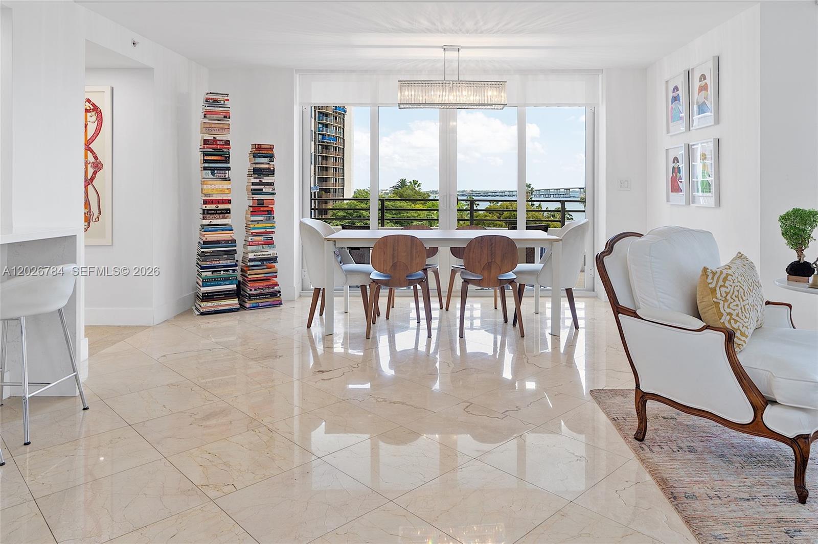 151 Southeast 15th Road, Unit 601 Miami, FL 33129 - Photo 6 of 36 a dining room with furniture and a floor to ceiling window