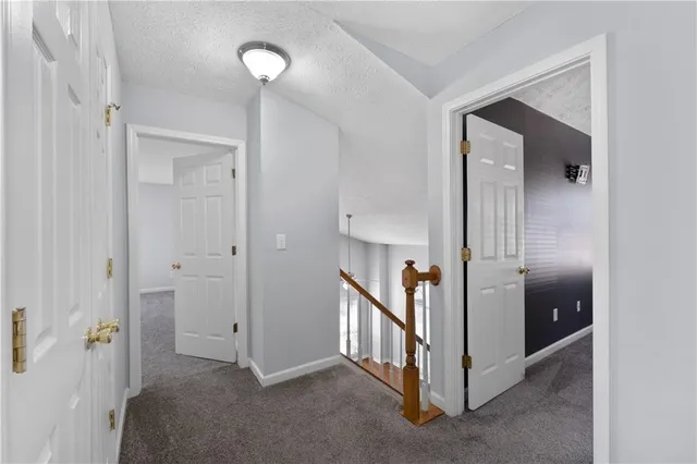a view of a hallway with closet and a livingroom view