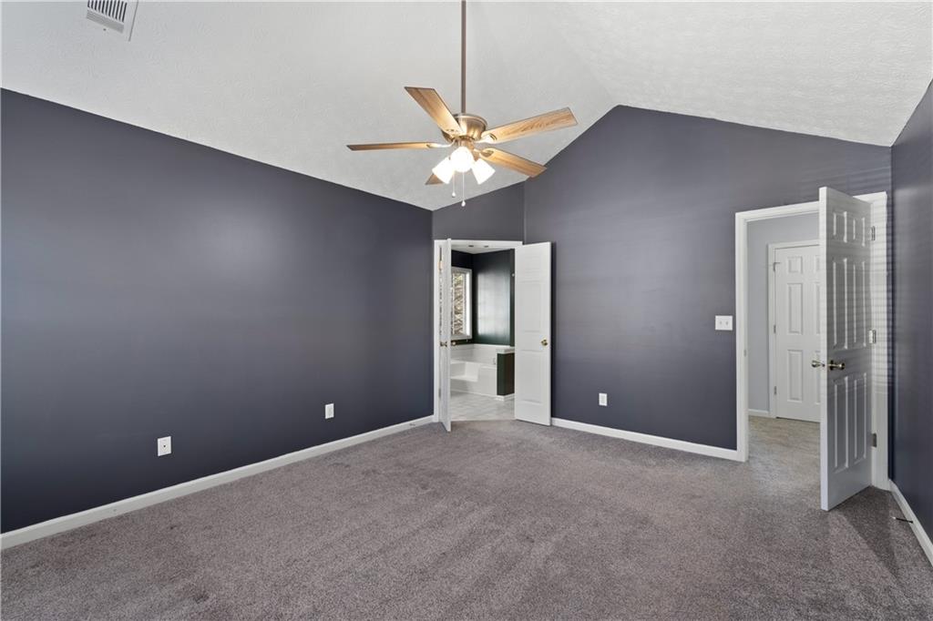 4240 Berkeley Mill Lane Duluth, GA 30096 - Photo 18 of 32 a view of an empty room with a ceiling fan