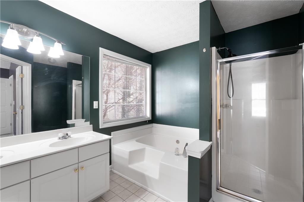 4240 Berkeley Mill Lane Duluth, GA 30096 - Photo 19 of 32 a bathroom with a tub sink and mirror