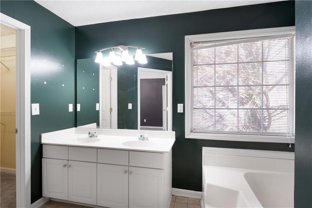4240 Berkeley Mill Lane Duluth, GA 30096 - Photo 20 of 32 a bathroom with a double vanity sink and a mirror