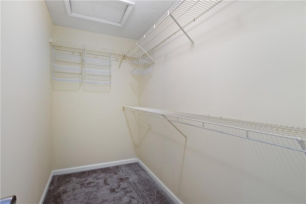 4240 Berkeley Mill Lane Duluth, GA 30096 - Photo 21 of 32 a view of a room with racks on the wall