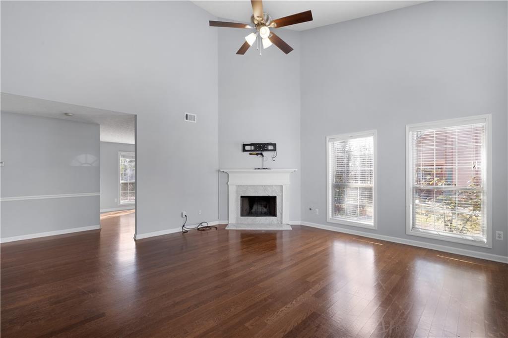 4240 Berkeley Mill Lane Duluth, GA 30096 - Photo 4 of 32 an empty room with windows fireplace and windows