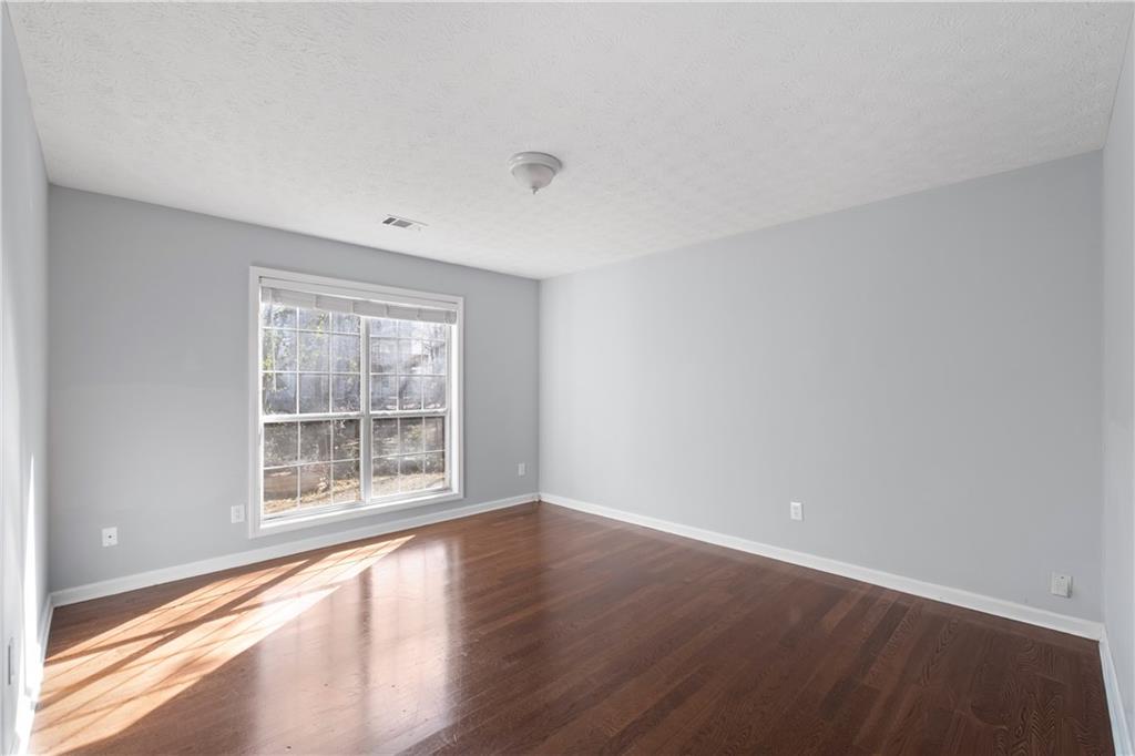 4240 Berkeley Mill Lane Duluth, GA 30096 - Photo 8 of 32 wooden floor in an empty room with a window