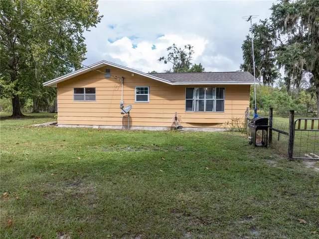 a spacious bedroom with a large bed and a chandelier