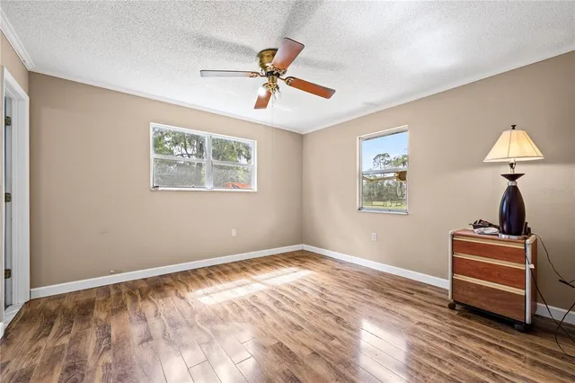 a view of empty room with wooden floor