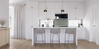 a kitchen with stainless steel appliances granite countertop a white cabinets and a stove top oven