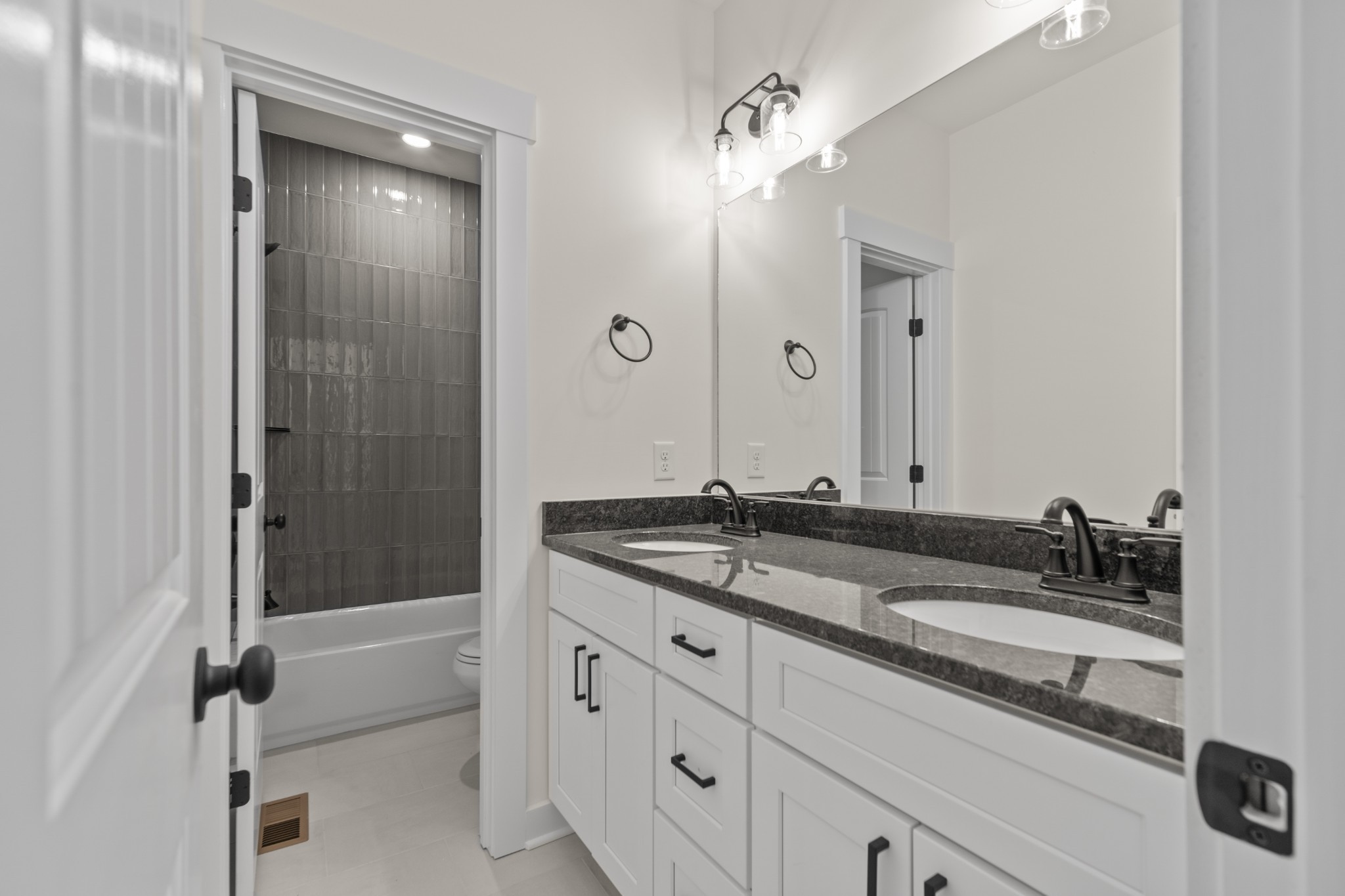 2969 Lights Chapel Road Greenbrier, TN 37073 - Photo 22 of 34 a bathroom with a granite countertop sink a mirror and a shower