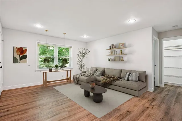 a living room with furniture and wooden floor