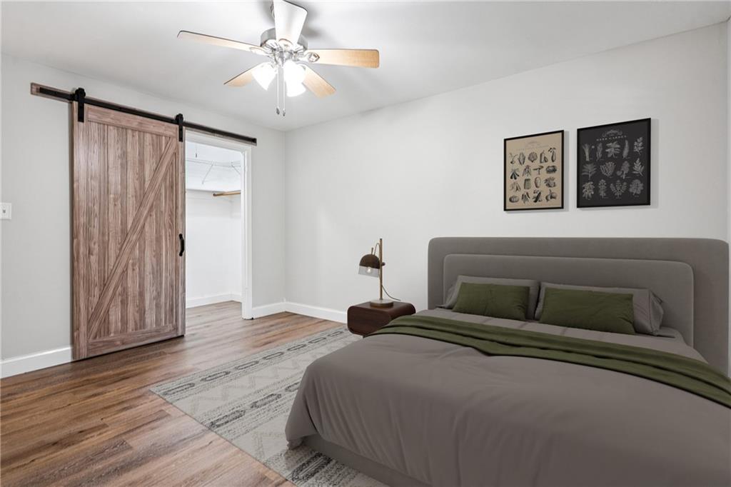 1010 Scott Boulevard, Unit A6 Decatur, GA 30030 - Photo 12 of 26 a bedroom with a bed and wooden floor
