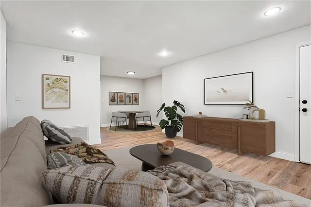 a living room with furniture and painting on the wall